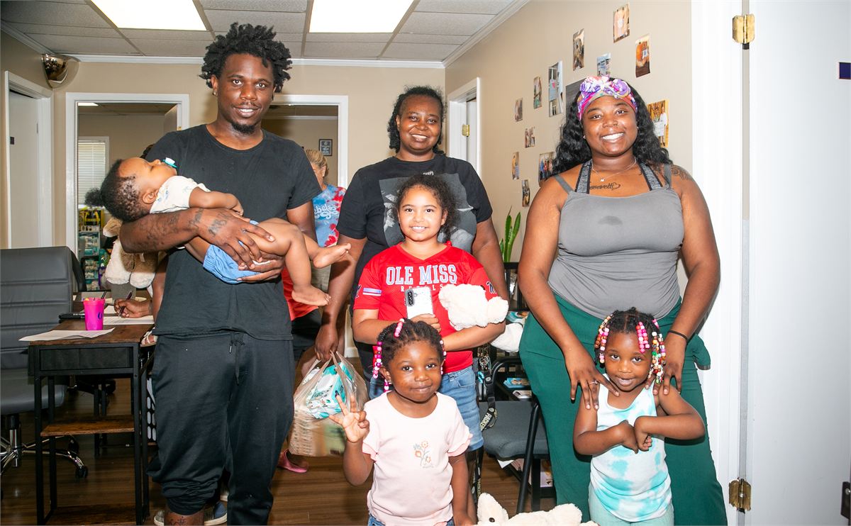 Family smiling together at the Oxford Diaper Bank